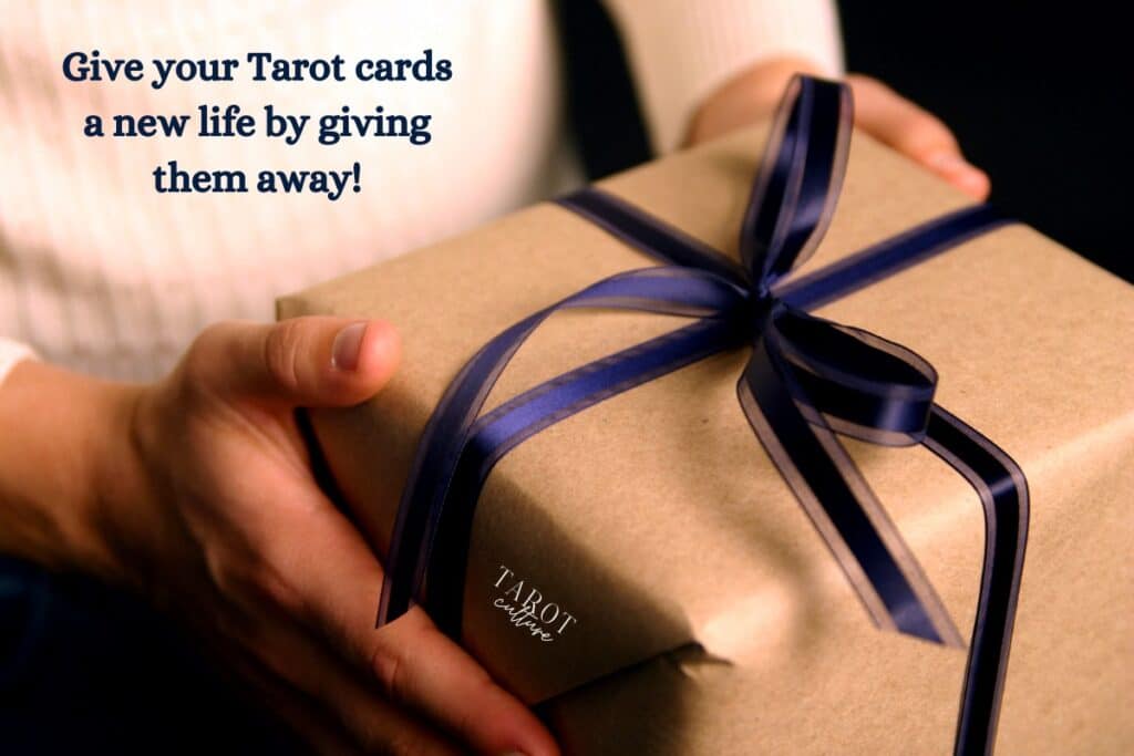 Handing a gift wrapped in brown paper with a purple bow, with the caption: "Give your Tarot cards a new life by giving them away"