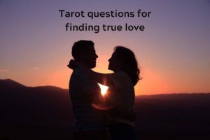 Couple hugging at sunset with caption "Tarot questions for finding true love"