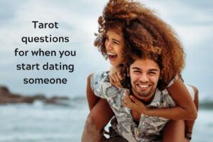 Couple hugging on the beach with caption "Tarot questions for when you start dating someone"