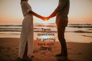 Couple holding hands on the beach at sunset with caption: "Tarot questions for getting back with your ex"